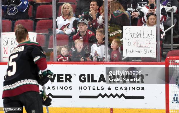 Fan holds up a sign as Brad Richardson of the Arizona Coyotes warms up prior to a game against the Los Angeles Kings at Gila River Arena on March 9,...