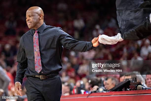 Head Coach Mike Anderson of the Arkansas Razorbacks takes off his jacket and throws it on the bench during a game against the Alabama Crimson Tide at...