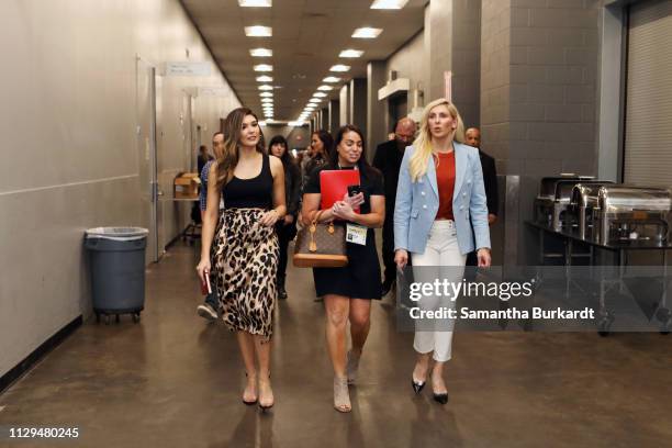 Cathy Kelley and Charlotte Flair walk backstage at Featured Session: The Womens Evolution in WWE and Beyond during the 2019 SXSW Conference and...