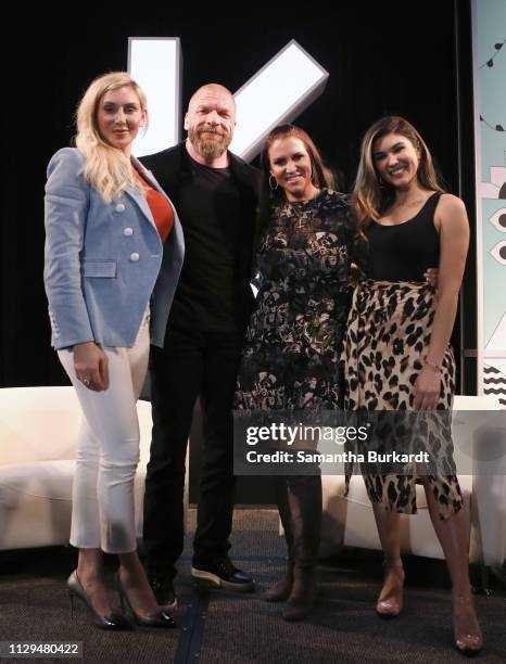 Charlotte Flair, Paul Michael Levesque aka 'Triple H', Stephanie McMahon, and Cathy Kelley pose onstage at Featured Session: The Womens Evolution in...