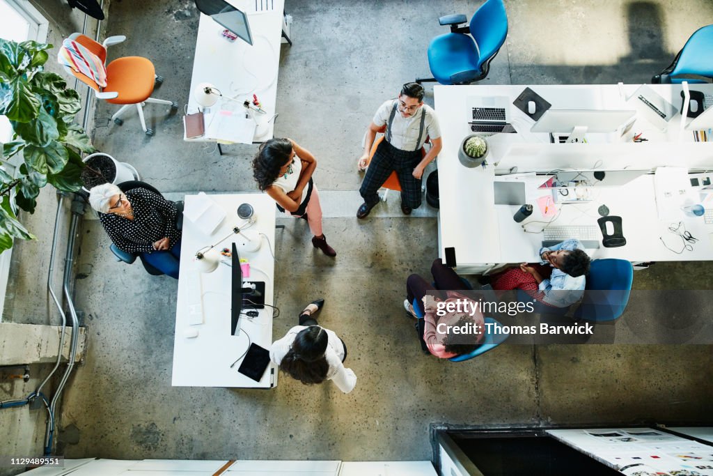 Overhead view of design team having project meeting in office