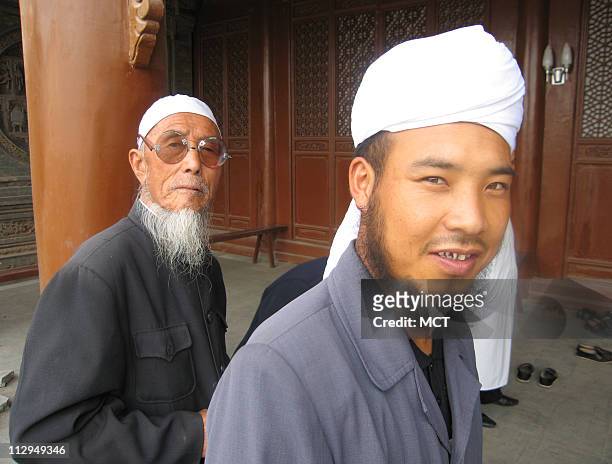 Ethnic Hui enter a mosque in Tongxin, China, for prayers. The Hui are China's largest Muslim minority. Hui men almost always wear a white cap or head...