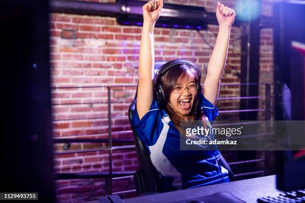 gamer celebrating while playing esports - gaming station stock pictures, royalty-free photos & images