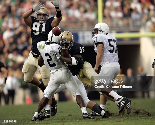 Notre Dame's Chinedum Ndukwe forces Penn State's Derrick Williams to fumble, after Williams had lined up as quarterback. Notre Dame defeated Penn...