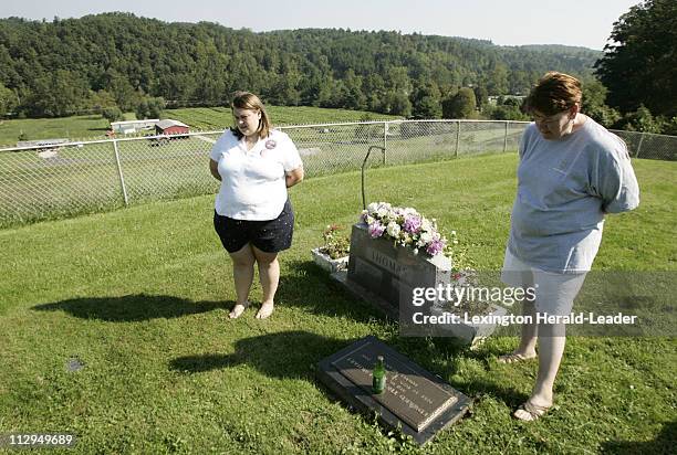 Charlotte Earhart, right, and her daughter, Andrea Earhart Stauter, visit the grave of Charlotte's son, Ed Earhart, at the family cemetery near...