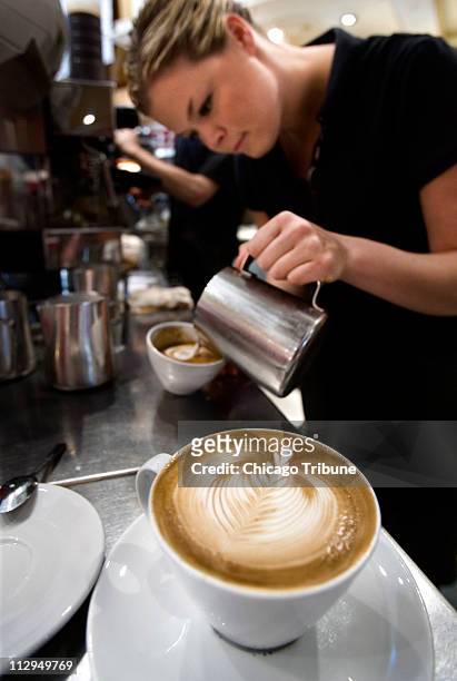 Lindsay Parker , one of the managers of Caffe Artigiano and last year's National Latte Art Champion for Canada, works her magic behind the the bar in...