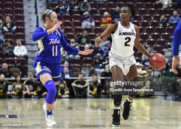 Knights Guard Kay Kay Wright brings the gallup the court while Tulsa Golden Hurricane Guard Maddie Bittle defends during the game as the Tulsa Golden...