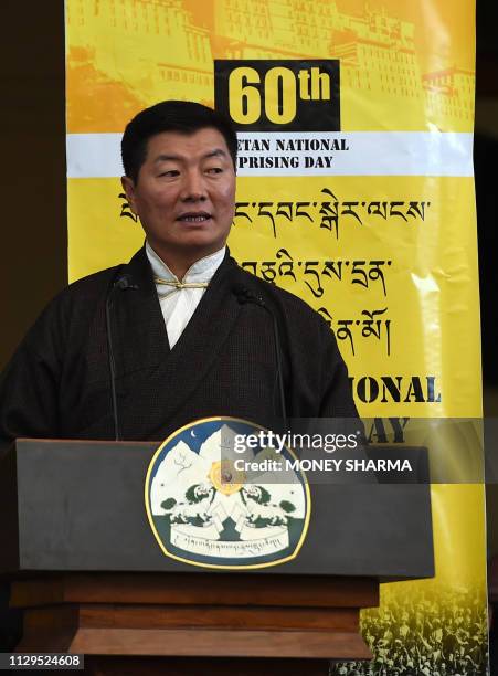 Prime Minister of the Tibetan government in exile Lobsang Sangay looks on as he addresses the gathering at the Dalai Lama's temple during the 60th...