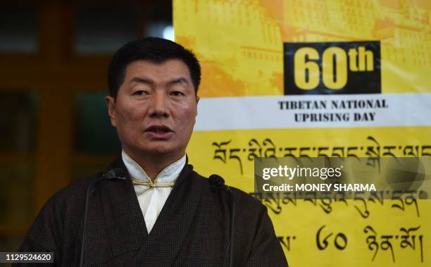 Prime Minister of the Tibetan government in exile Lobsang Sangay addresses the gathering at the Dalai Lama's temple during the 60th anniversary of...