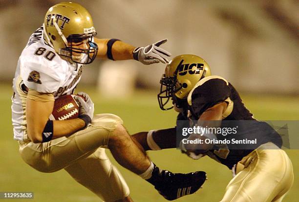 PItt tight end Nate Byham is hit by University of Central Florida defensive back Joe Burnett during game action at the Citrus Bowl in Orlando,...