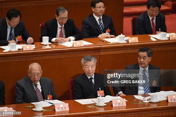 Former Hong Kong chief executives Leung Chun-ying and Tung Chee-hwa listen to speeches during a plenary session of the Chinese People's Political...