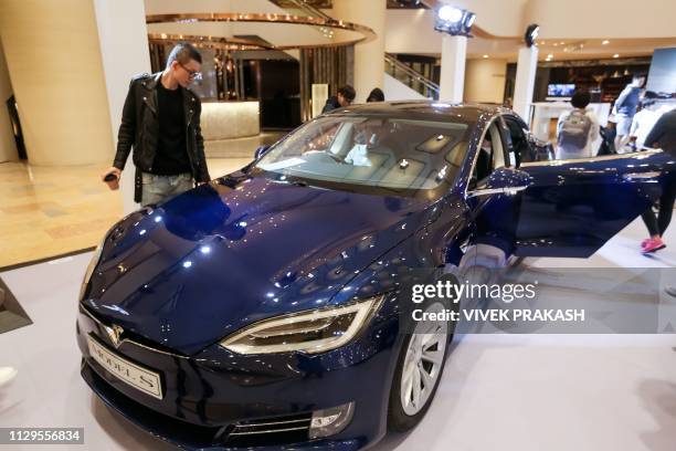 Tesla Model S is displayed at a shopping mall in Hong Kong on March 10, 2019. - Electric carmaker Tesla has won more than 520 million USD in loans...