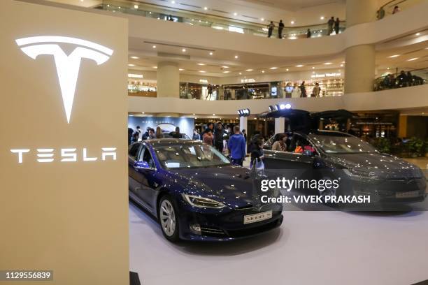 Tesla Model S and Model X are displayed at a shopping mall in Hong Kong on March 10, 2019. - Electric carmaker Tesla has won more than 520 million...