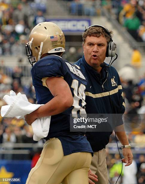 Navy head coach Paul Johnson congratulates quarterback Kaipo-Noa Kaheaku-Enhada after he scored a touchdown against Notre Dame in the first half of...