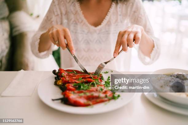 tourist woman eating in restaurant - eating vegan food stock pictures, royalty-free photos & images