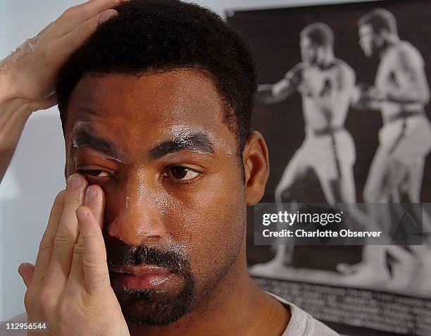 Trainer Tom Yankello covers Charlotte, North Carolina native Calvin Brocks' face with Vaseline prior to sparring three rounds with David Cadieux...