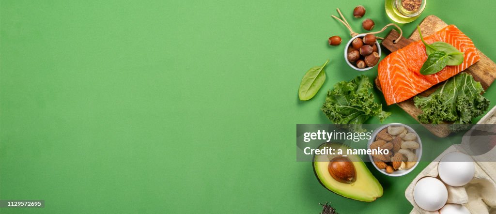 Keto diet concept - salmon, avocado, eggs, nuts and seeds