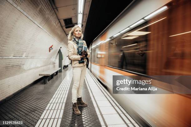 mature woman using subway to get to work - person of the year honoring caetano veloso roaming inside stockfoto's en -beelden