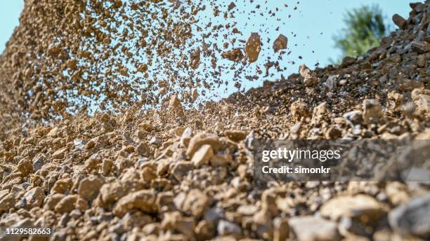 gravel falling of digger at construction site - pile of rocks stock pictures, royalty-free photos & images