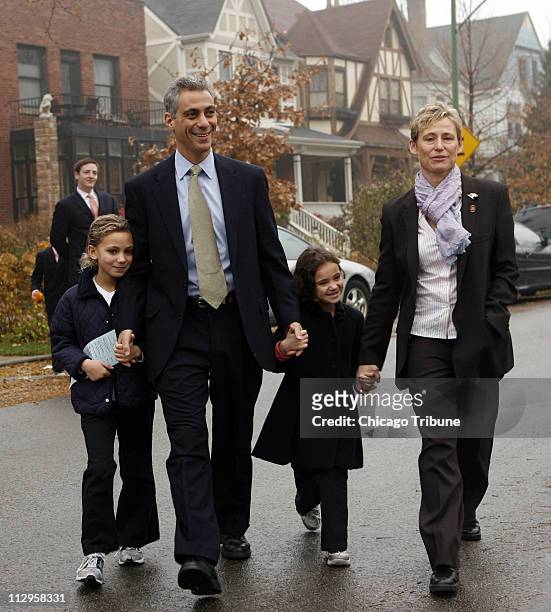 Rep. Rahm Emanuel walks with his family, daughters Ilana, left, and Leah, and wife Amy Rule, as they head to a polling place in Chicago, Illinois, on...