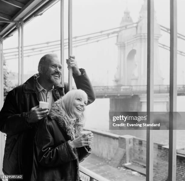 English actor Harry Andrews and English actress and fashion model Barbara Ferris on the Thames south riverbank near Hammersmith Bridge, London, UK,...