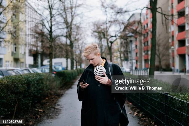 Single Mother Looking At Phone While Outisde