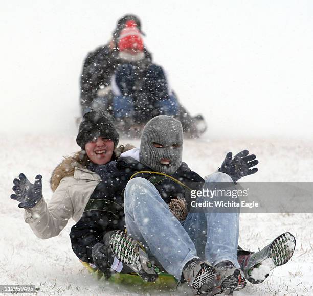 Laura Wallin and Jackson Shaad sled together with friends from East High School in Wichita, Kansas, Thursday, November 30, 2006.