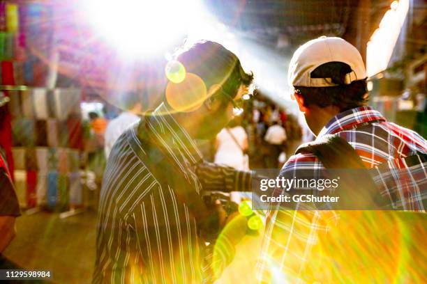 friends exploring dubai's local traditional souq - middle east market stock pictures, royalty-free photos & images