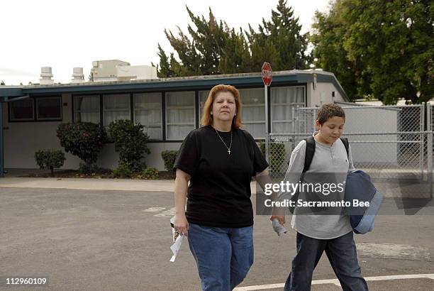 Alicia Solorzano picks up her 11-year-old son, Esteban Solorzano, at King Elementary School after officials locked down classroom doors on Thursday,...