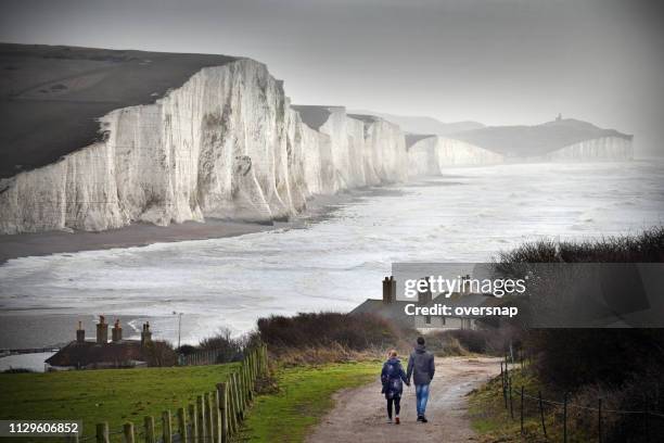 walking couple - seven sisters cliffs stock pictures, royalty-free photos & images