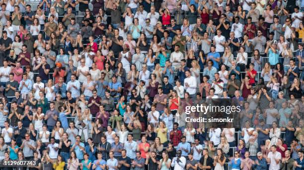 spectators cheering in stadium - crowd cheer stadium clapping stock pictures, royalty-free photos & images