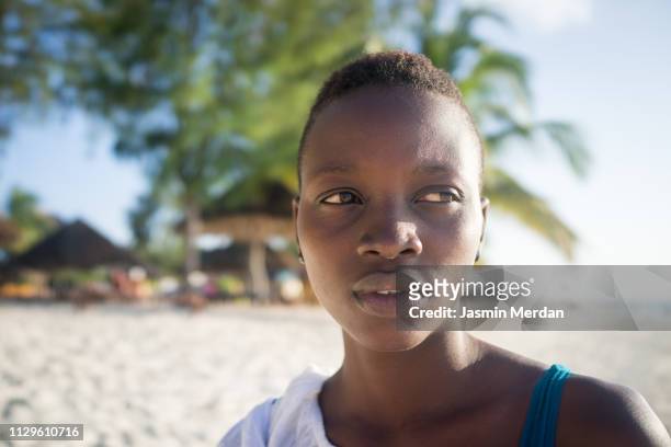 african girl on palm beach - black woman hair back stock pictures, royalty-free photos & images
