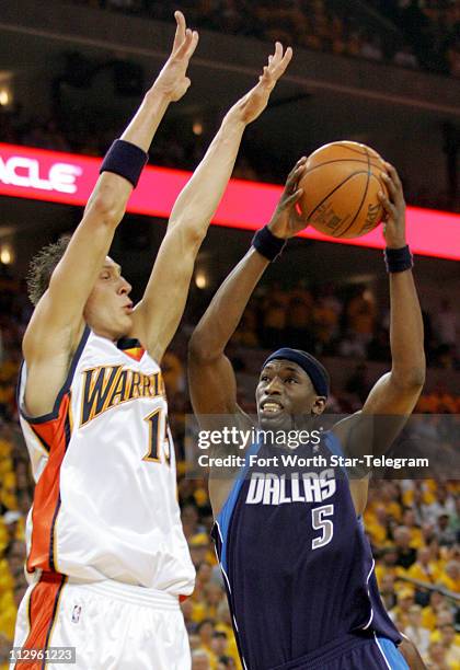 Golden State Warriors Andris Biedrins guards Dallas Mavericks Josh Howard in the first period during Game 3 of the NBA Western Conference Playoffs in...