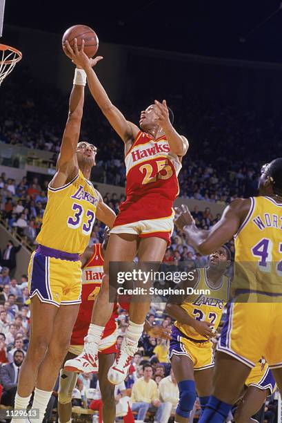 Glenn "Doc" Rivers of the Atlanta Hawks shoots over Kareem Abdul-Jabbar of the Los Angeles Lakers during a NBA game at the Great Western Forum in...