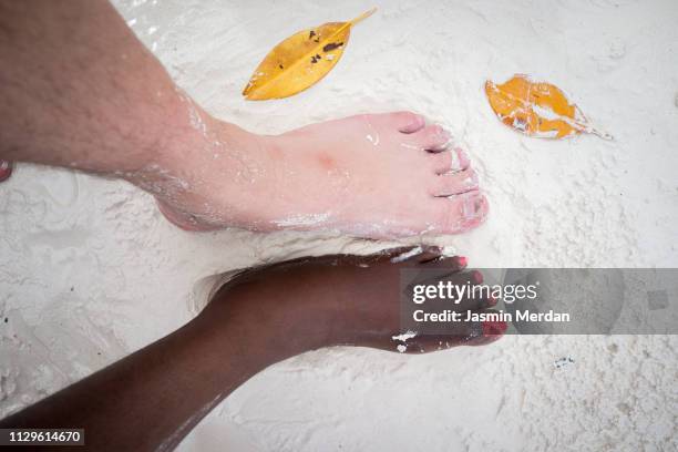 black and white feet in beach sand - black feet couple stock pictures, royalty-free photos & images