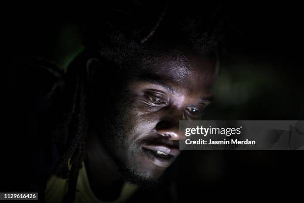 african man night portrait - glowing face stock pictures, royalty-free photos & images