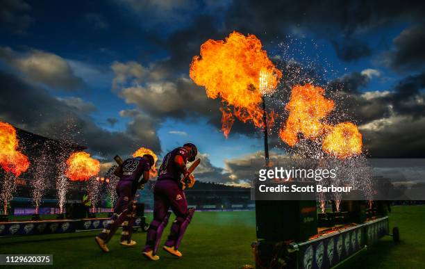 Matthew Wade and D'Arcy Short of the Hurricanes walk out to bat through flames during the Big Bash League semi final match between the Hobart...