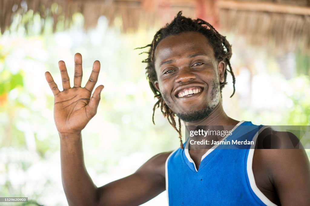African man saying hello