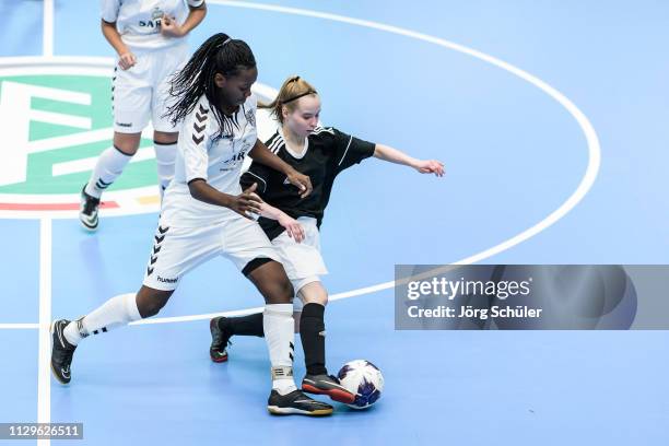 Girl of DFC Westsachsen-Zwickau is challenged by a girl of Harburger TB during the Futsal-Cup 2019 of the B-Juniors on March 10, 2019 in Wuppertal,...