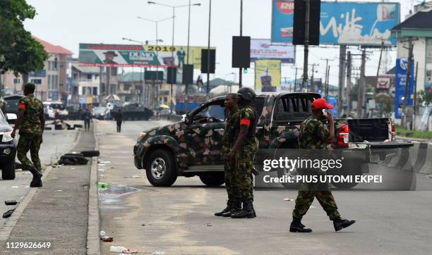 Soldiers block with truck and armoured tank the road leading to the state headquarters of Independent National Electoral Commission in Port Harcourt,...