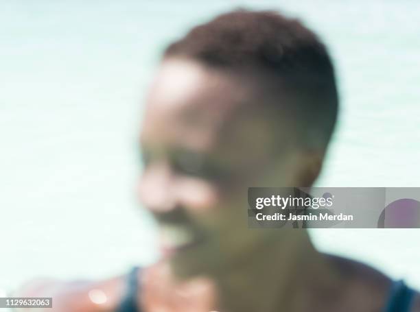 defocused portrait of african young woman - backgrounds people stock-fotos und bilder