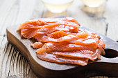 Homemade smoked salmon on wooden board