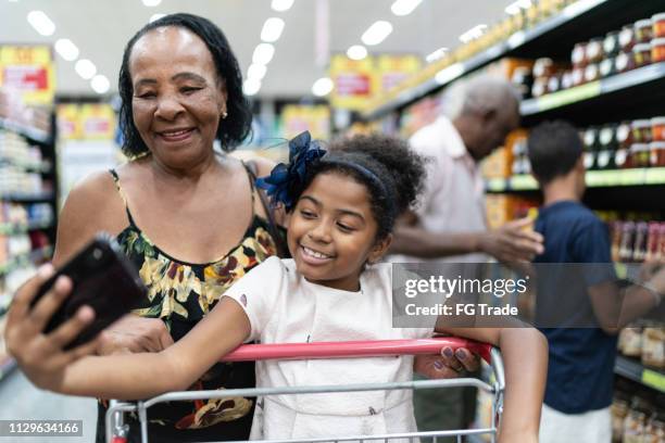 family together at grocery store - older black people shopping stock pictures, royalty-free photos & images