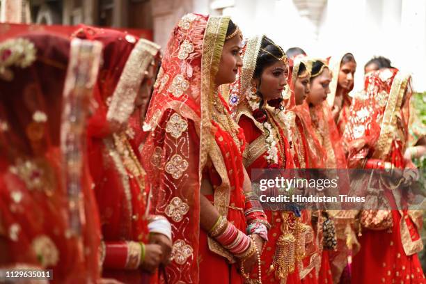 Group of brides seen during a mass wedding for eight couples at Hanuman Vatika, Ramleela Maidan, on March 8, 2019 in New Delhi, India. The purpose of...