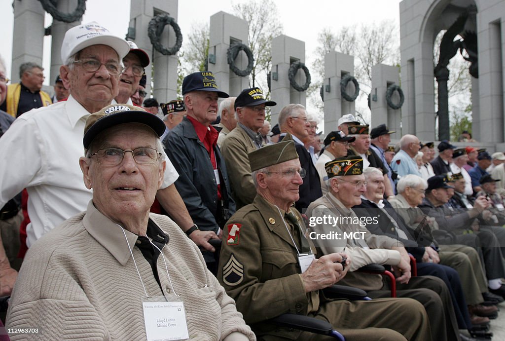 Lloyd Lobitz of Watertown, Minnesota, left, awaits a group p