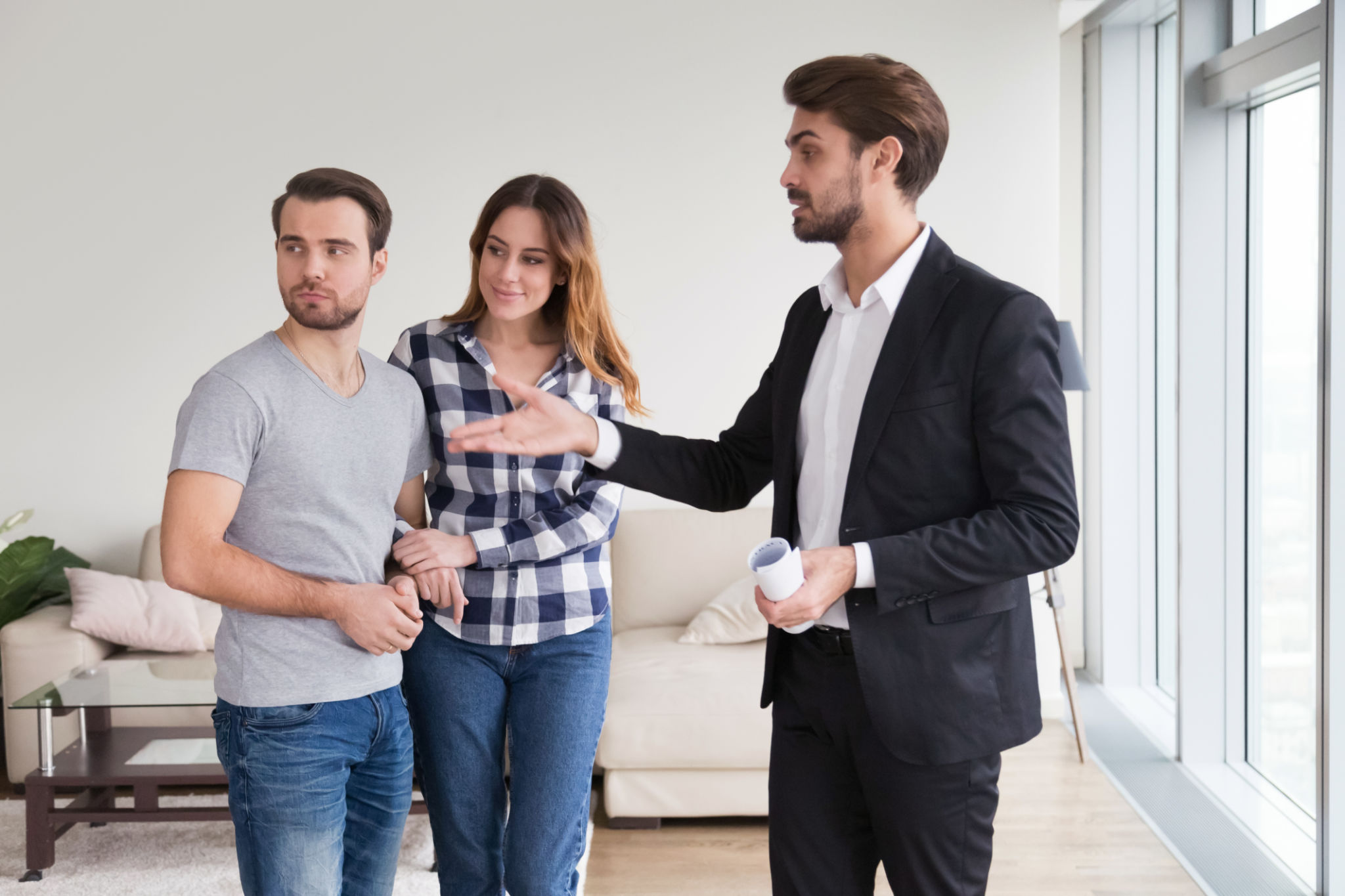 Real Estate Agent or landlord showing house apartment to young couple Real Estate Agent or landlord showing house apartment to young couple