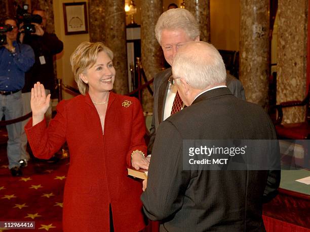 Former President Bill Clinton holds the Bible as his wife, Sen. Hillary Rodham Clinton , re-enacts her Senate swearing-in with Vice-President Dick...