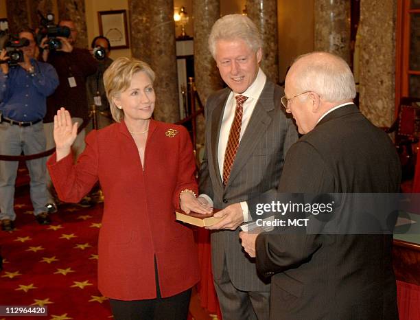 Former President Bill Clinton holds the Bible as his wife, Sen. Hillary Rodham Clinton , re-enacts her Senate swearing-in with Vice-President Dick...