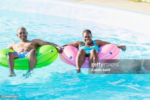 mature african-american couple on water park lazy river - lazy river stock pictures, royalty-free photos & images