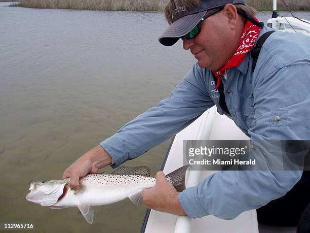 Captain Chuck Simpson releases a sea trout caught in the St. Marks National Wildlife Refuge in St. Marks, Florida.